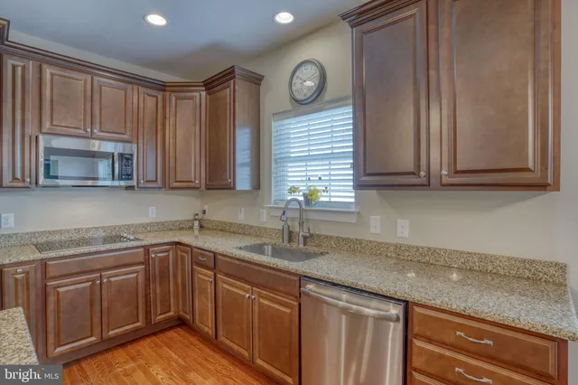 a kitchen with stainless steel appliances granite countertop a sink and cabinets