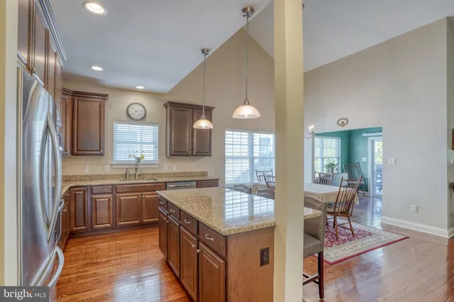 a living room with furniture a chandelier and a dining table