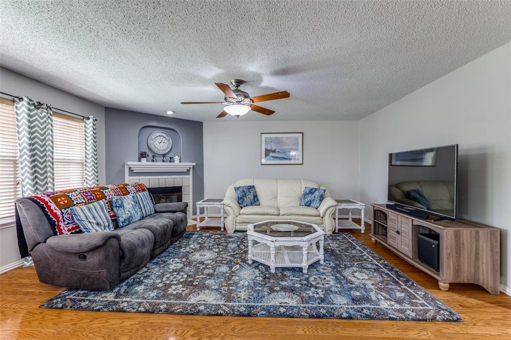 1017 Lake Trail Drive Little Elm, TX 75068 - Photo 12 of 35 a living room with furniture a rug and a flat screen tv