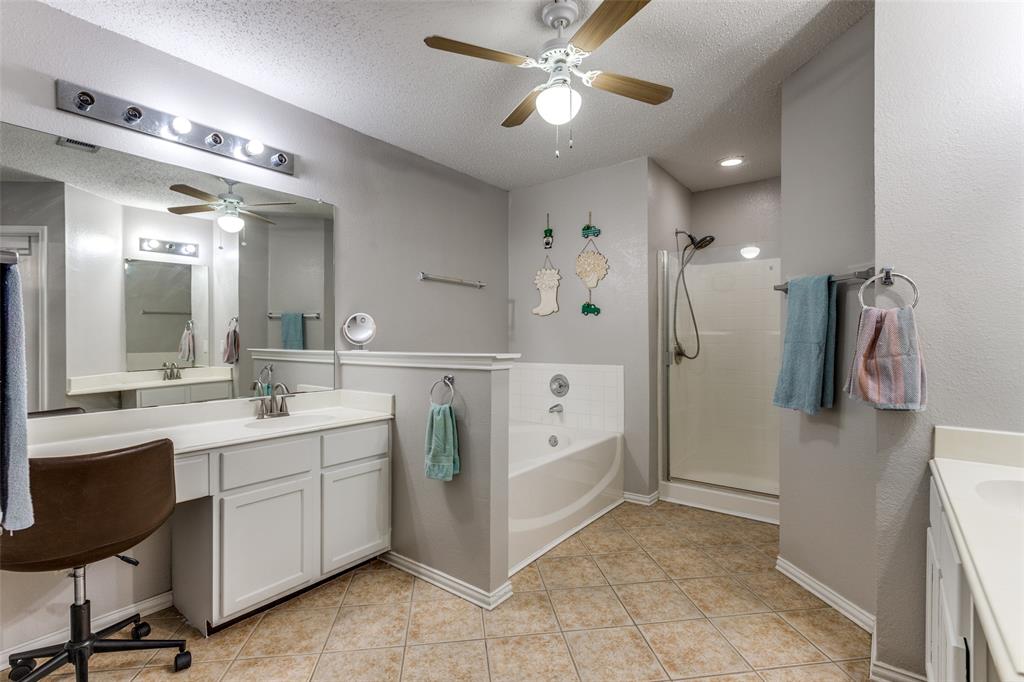 1017 Lake Trail Drive Little Elm, TX 75068 - Photo 23 of 35 a spacious bathroom with a double vanity sink a mirror a vanity and a shower