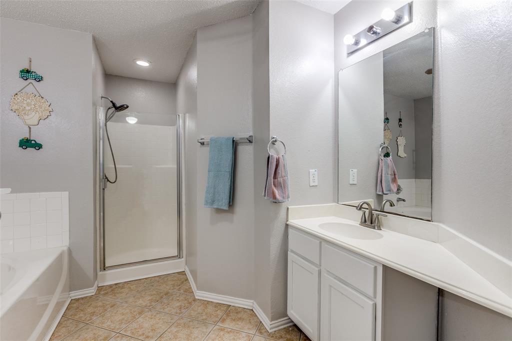 1017 Lake Trail Drive Little Elm, TX 75068 - Photo 24 of 35 a bathroom with a double vanity sink a shower and a mirror