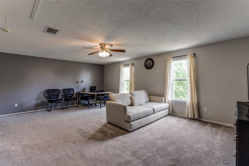 1017 Lake Trail Drive Little Elm, TX 75068 - Photo 26 of 35 a living room with furniture and a chandelier