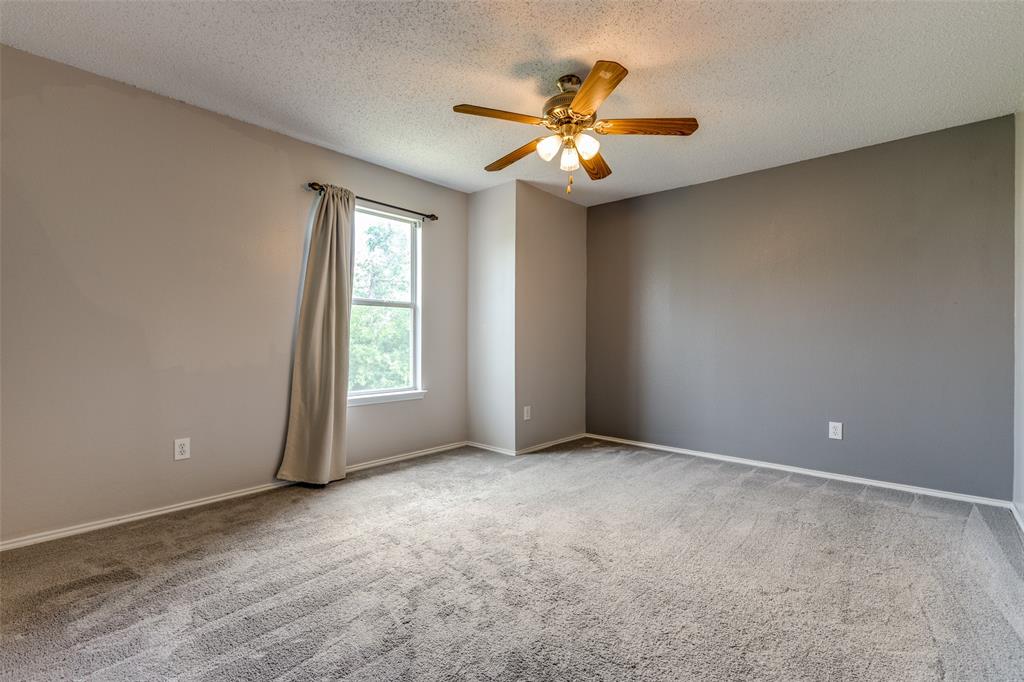 1017 Lake Trail Drive Little Elm, TX 75068 - Photo 28 of 35 a view of an empty room with chandelier fan and fire place