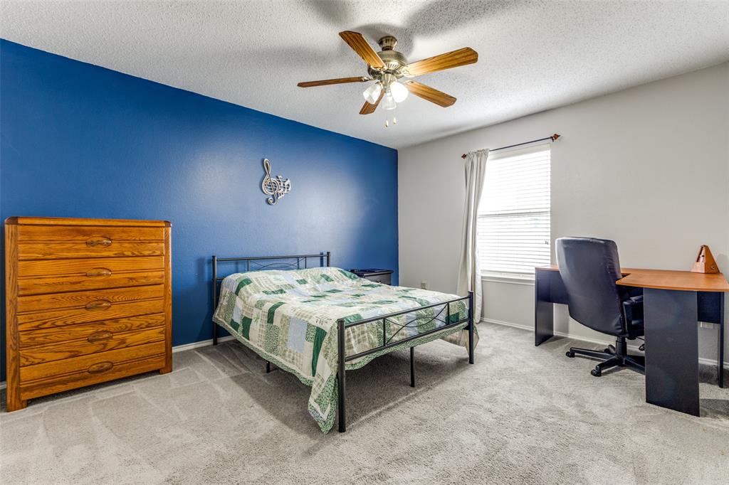 1017 Lake Trail Drive Little Elm, TX 75068 - Photo 29 of 35 a bedroom with a bed and a desk