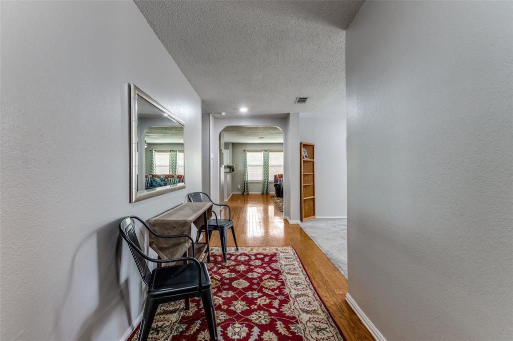 1017 Lake Trail Drive Little Elm, TX 75068 - Photo 5 of 35 a view of a hallway with furniture and wooden floor