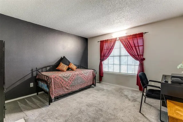 a bedroom with a bed and a fireplace