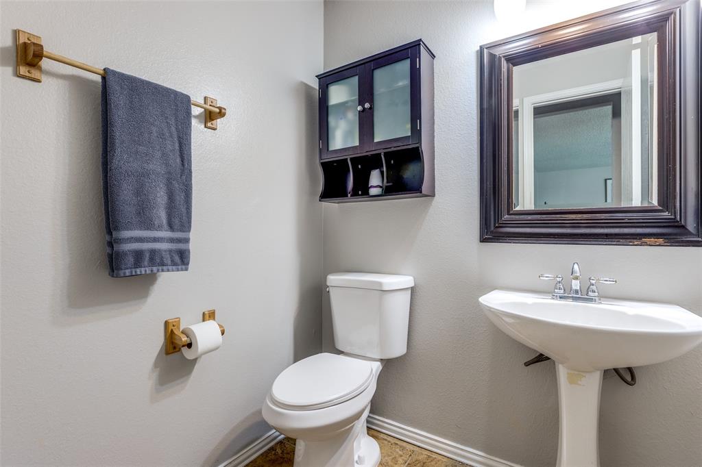 1017 Lake Trail Drive Little Elm, TX 75068 - Photo 9 of 35 a bathroom with a toilet sink and mirror
