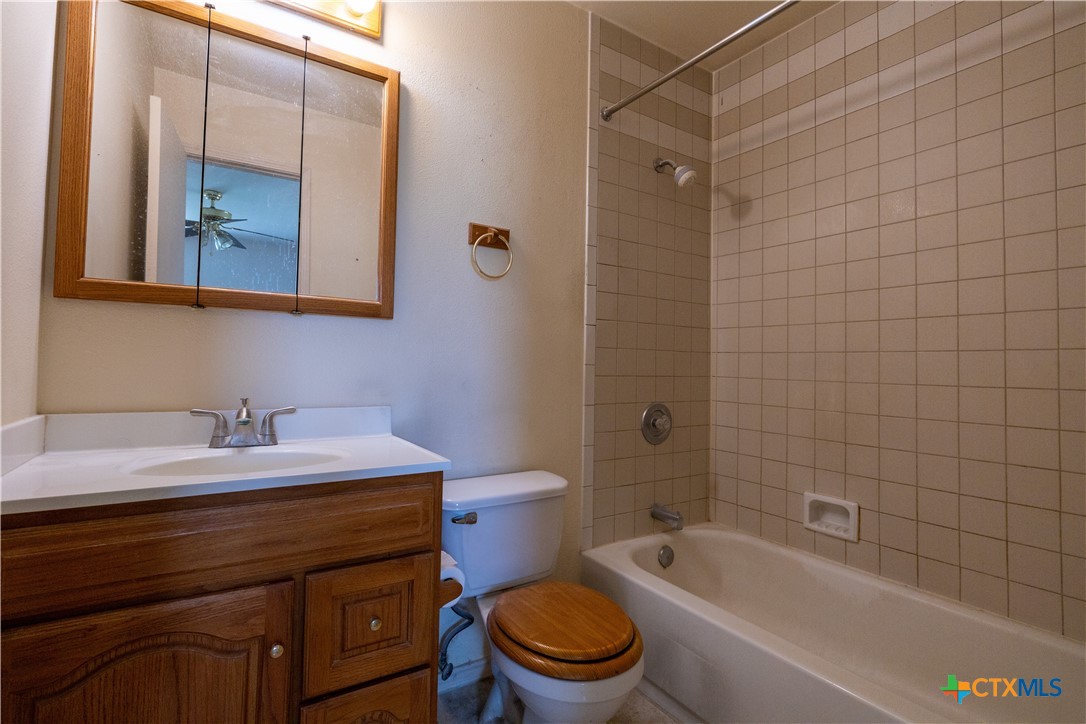 199 Sunset Trail Luling, TX 78648 - Photo 17 of 34 a bathroom with a sink a toilet and shower