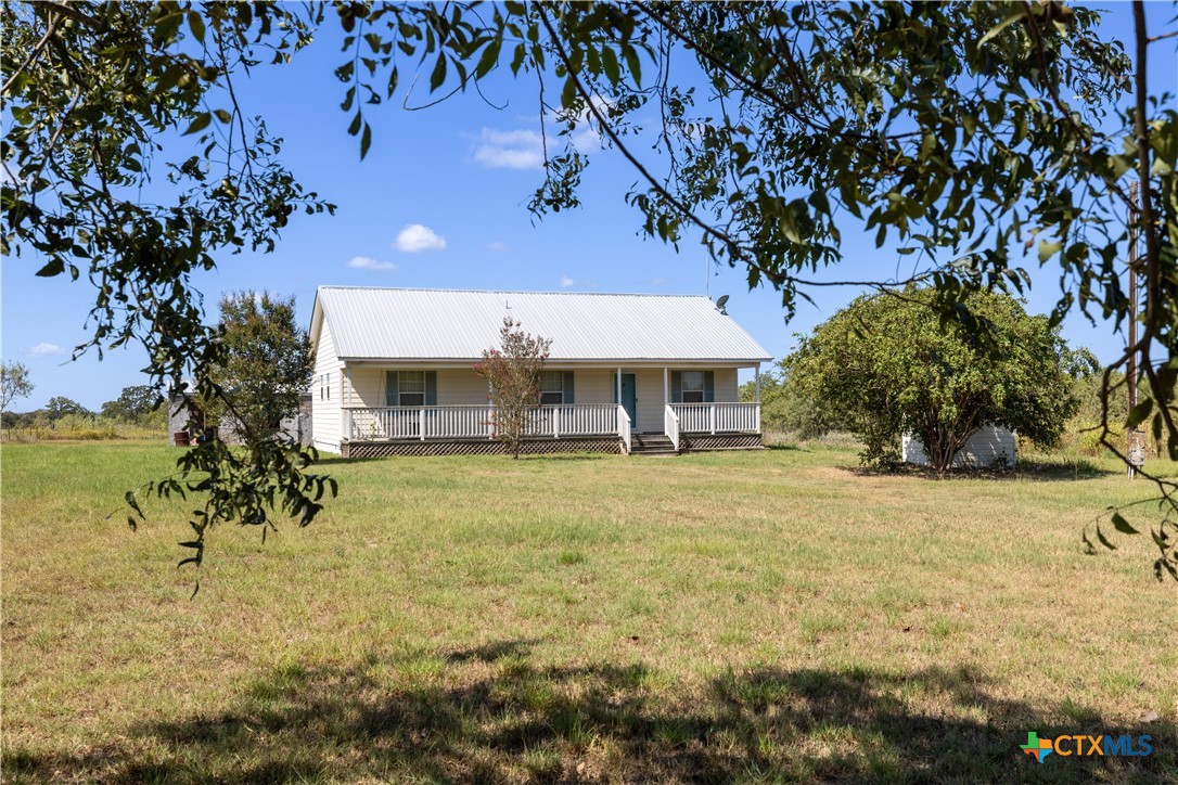 199 Sunset Trail Luling, TX 78648 - Photo 21 of 34 a front view of a house with garden