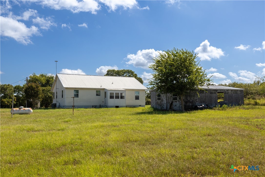 199 Sunset Trail Luling, TX 78648 - Photo 23 of 34 a view of a house with a yard and garage