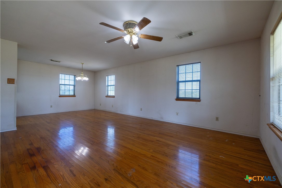 199 Sunset Trail Luling, TX 78648 - Photo 5 of 34 a view of empty room with wooden floor and fan