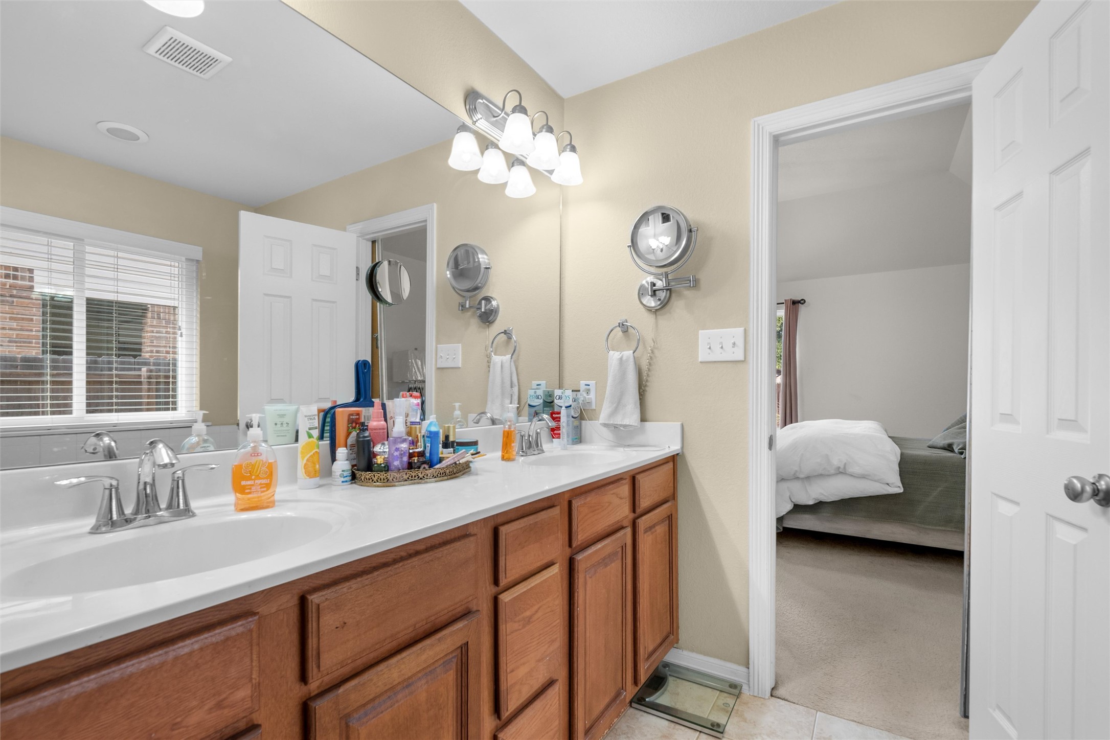 20704 Windmill Ridge Street Pflugerville, TX 78660 - Photo 20 of 34 A generous double vanity with ample counter space and well-lit mirrors provides functionality for daily routines.