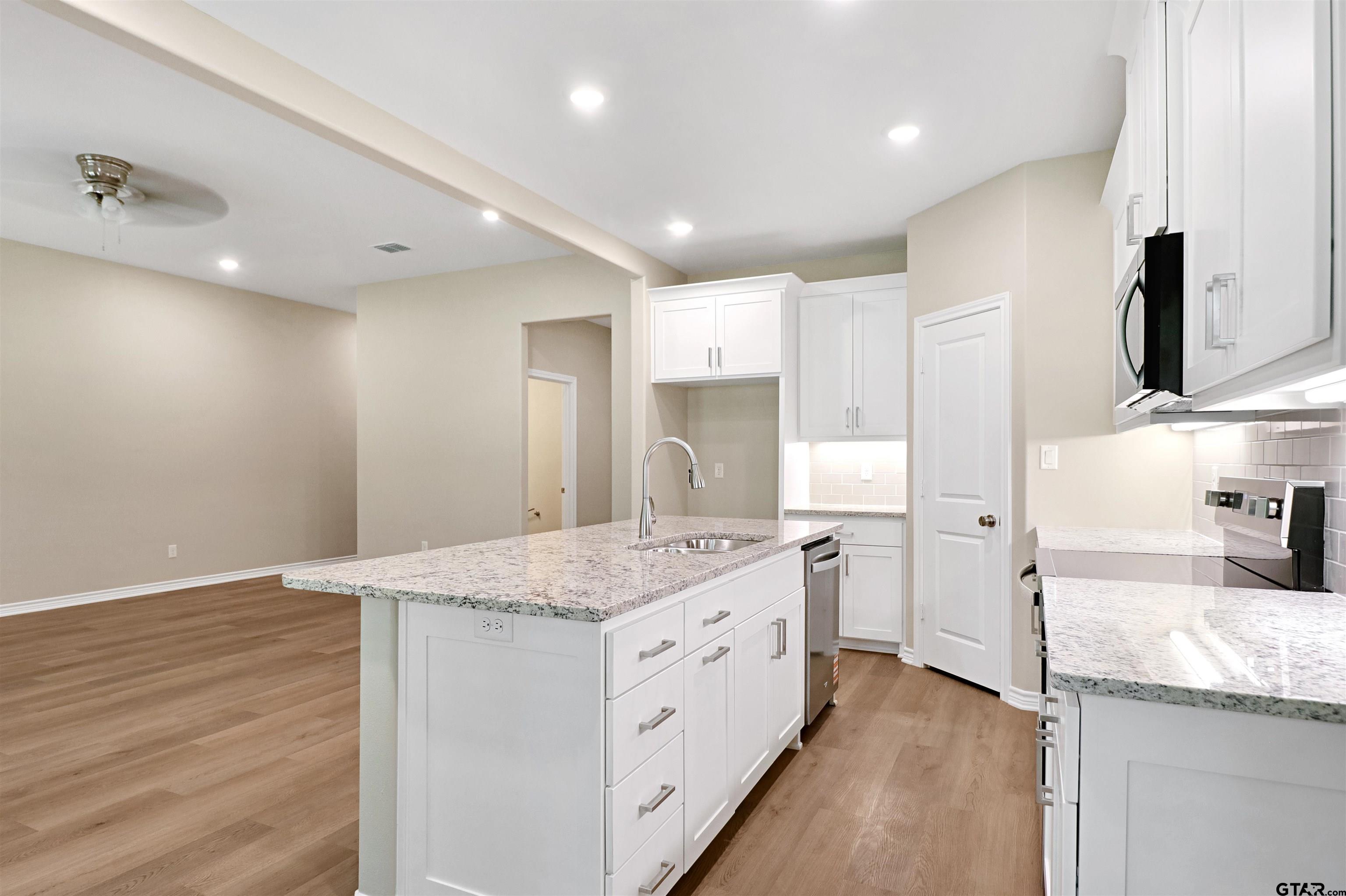 3053 Guinn Farms Road Tyler, TX 75707 - Photo 12 of 32 a kitchen with a sink stove and refrigerator