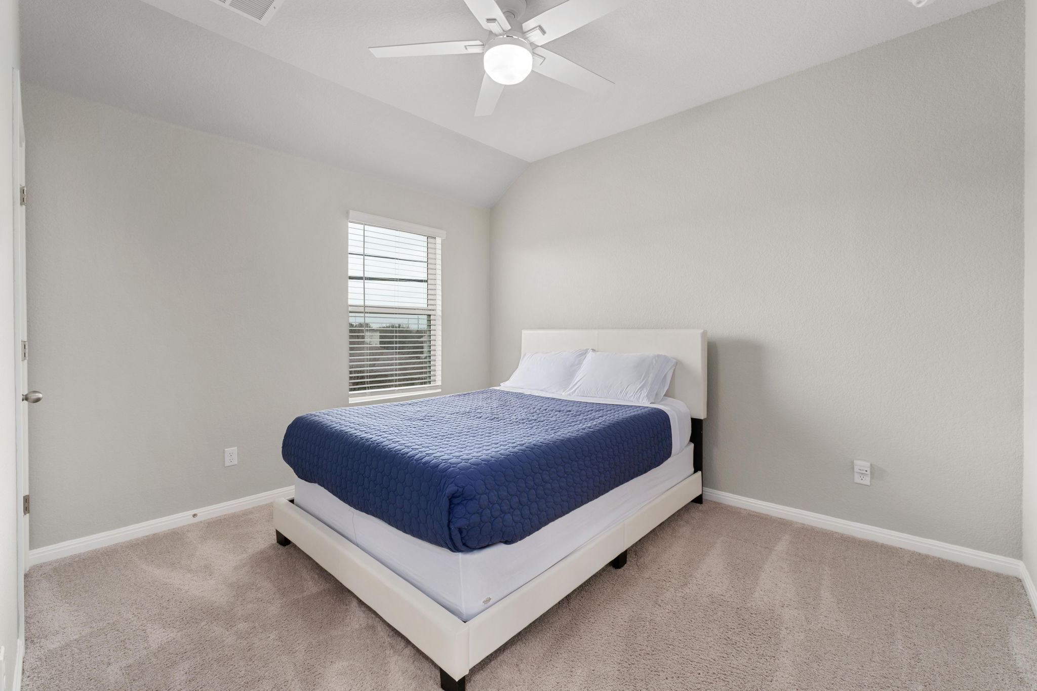 1008 Testoa Cove Hutto, TX 78634 - Photo 17 of 26 Bedroom featuring carpet floors, lofted ceiling, and ceiling fan