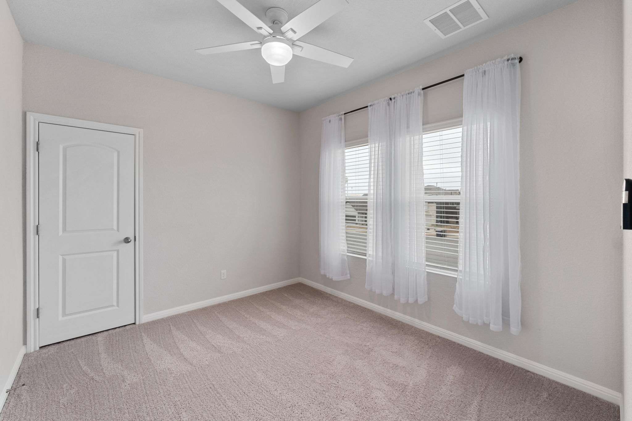 1008 Testoa Cove Hutto, TX 78634 - Photo 19 of 26 Spare room featuring light colored carpet and ceiling fan