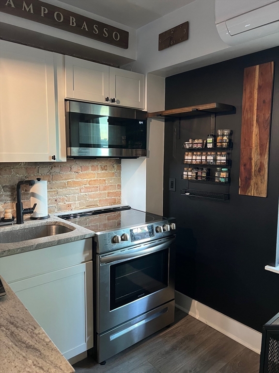 27 Swallow Street, Unit 3 Boston, MA 02127 - Photo 4 of 8 a kitchen with stainless steel appliances a stove and a microwave