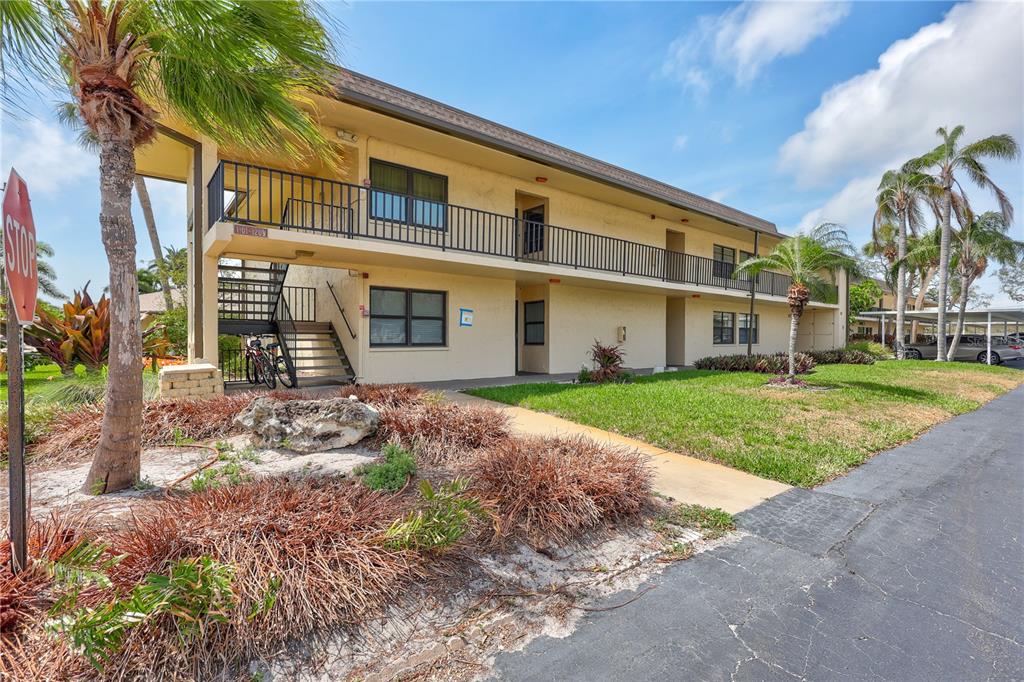 12300 Vonn Road, Unit 1102 Largo, FL 33774 - Photo 1 of 45 a front view of a house with garden