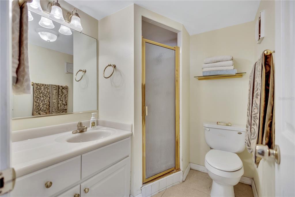 12300 Vonn Road, Unit 1102 Largo, FL 33774 - Photo 17 of 45 a bathroom with a toilet sink and a mirror