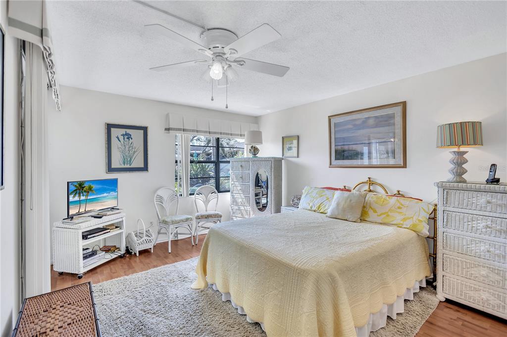 12300 Vonn Road, Unit 1102 Largo, FL 33774 - Photo 20 of 45 a bed room with a bed and a chandelier