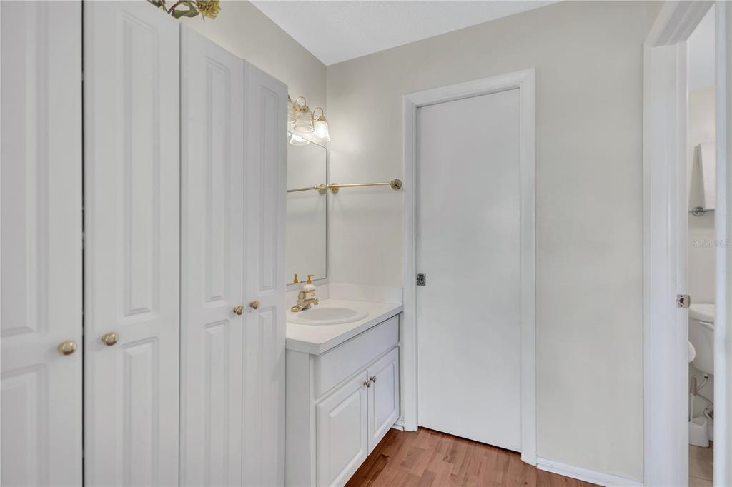 12300 Vonn Road, Unit 1102 Largo, FL 33774 - Photo 23 of 45 a bathroom with a double vanity sink a mirror and a shower