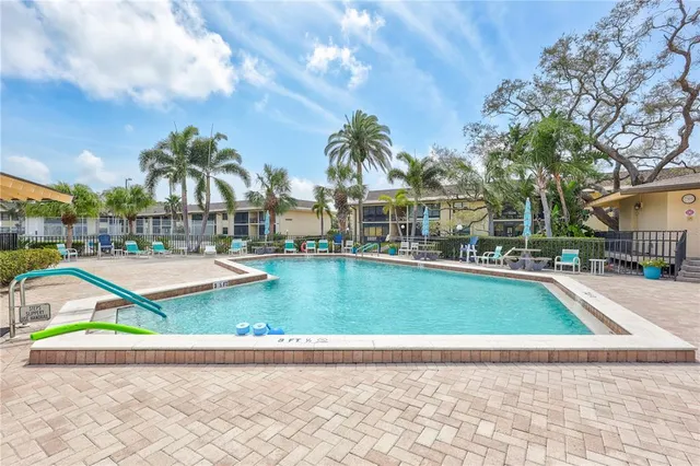 a view of a swimming pool and trees in the background