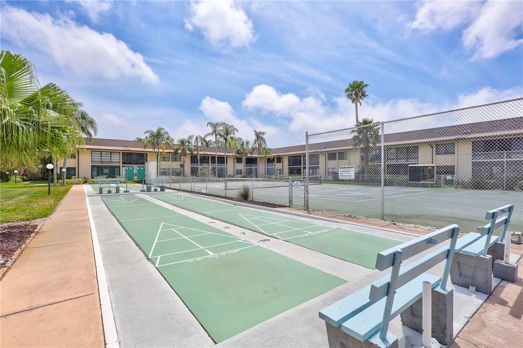 12300 Vonn Road, Unit 1102 Largo, FL 33774 - Photo 28 of 45 a view of a patio with a table and chairs
