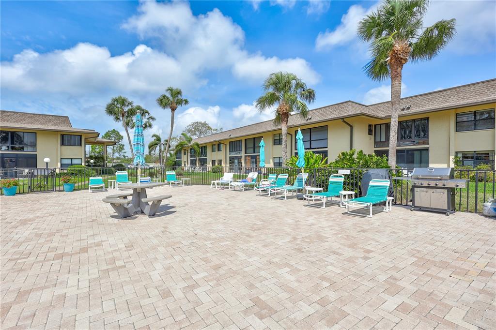 12300 Vonn Road, Unit 1102 Largo, FL 33774 - Photo 30 of 45 a view of a house with sitting area and fire pit