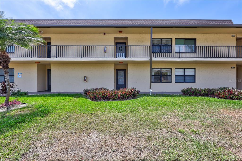 12300 Vonn Road, Unit 1102 Largo, FL 33774 - Photo 37 of 45 front view of a house with a yard