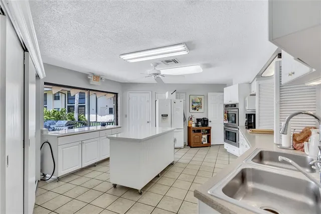 a kitchen with stainless steel appliances granite countertop a sink and cabinets