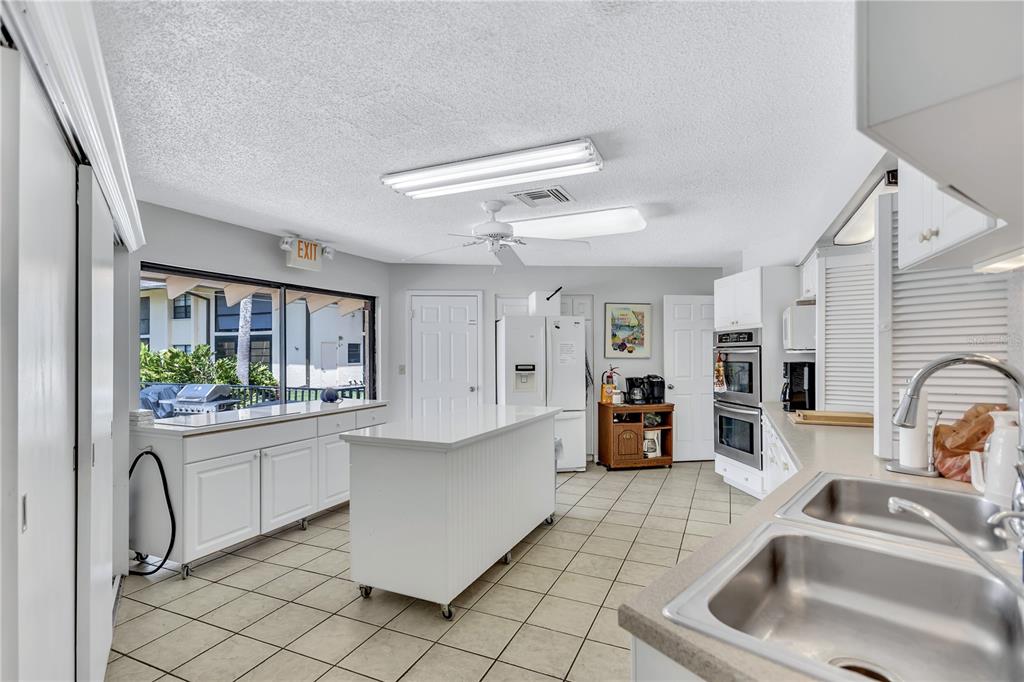 12300 Vonn Road, Unit 1102 Largo, FL 33774 - Photo 40 of 45 a kitchen with stainless steel appliances granite countertop a sink and cabinets