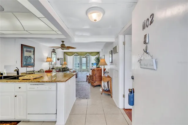 a spacious bathroom with a granite countertop sink a mirror and shower