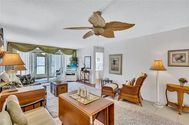 a living room with furniture a rug and a large window