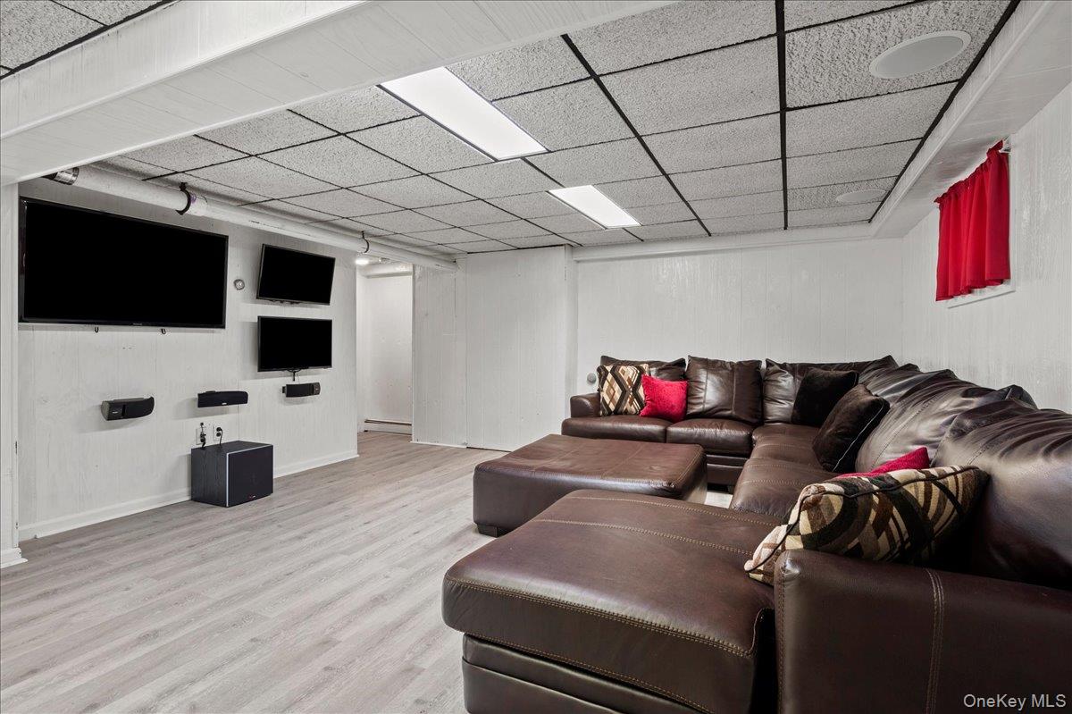 105 High St Extension Mount Kisco, NY 10549 - Photo 34 of 38 a living room with furniture and a flat screen tv