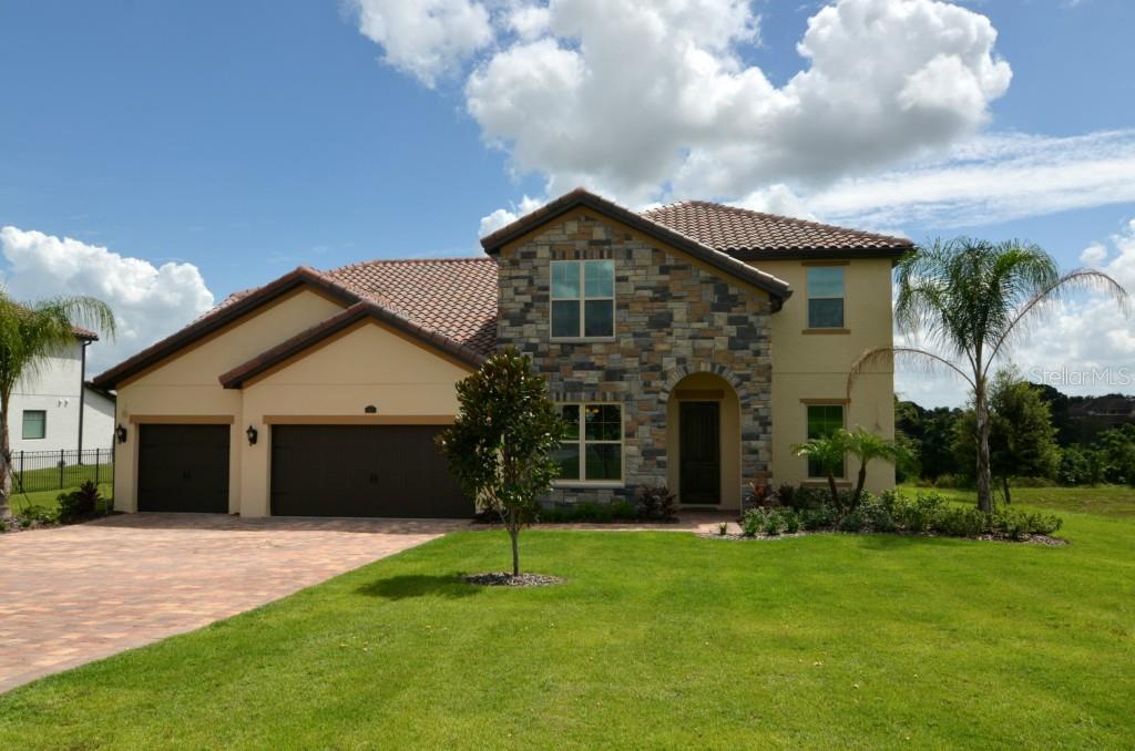 16812 Caravaggio Loop Montverde, FL 34756 - Photo 1 of 1 a front view of a house with a garden