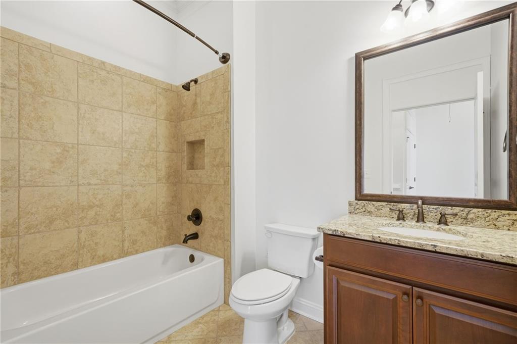 655 Hemlock Trail Canton, GA 30114 - Photo 15 of 58 a bathroom with a granite countertop sink a toilet and shower