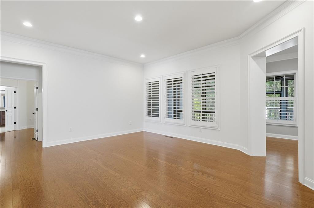 655 Hemlock Trail Canton, GA 30114 - Photo 24 of 58 a view of an empty room with wooden floor and a window