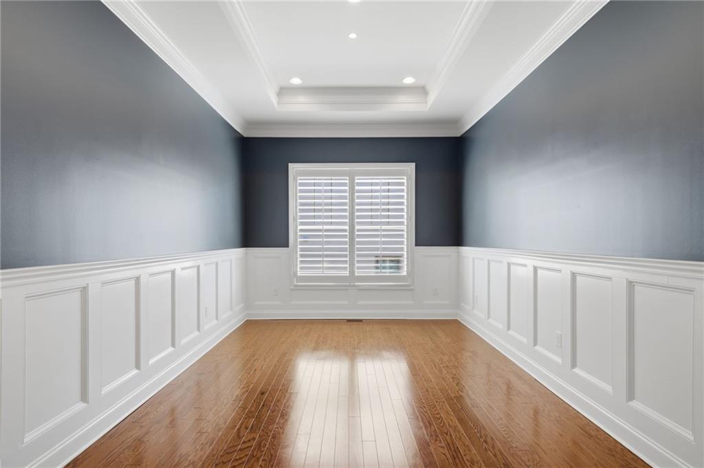 655 Hemlock Trail Canton, GA 30114 - Photo 25 of 58 a view of an empty room with wooden floor and a window
