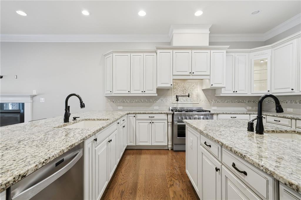 655 Hemlock Trail Canton, GA 30114 - Photo 28 of 58 a kitchen with granite countertop white cabinets and appliances