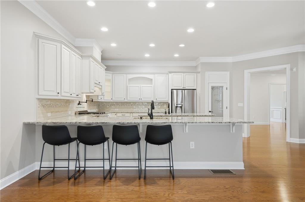 655 Hemlock Trail Canton, GA 30114 - Photo 34 of 58 a kitchen with stainless steel appliances granite countertop a stove a sink and a refrigerator