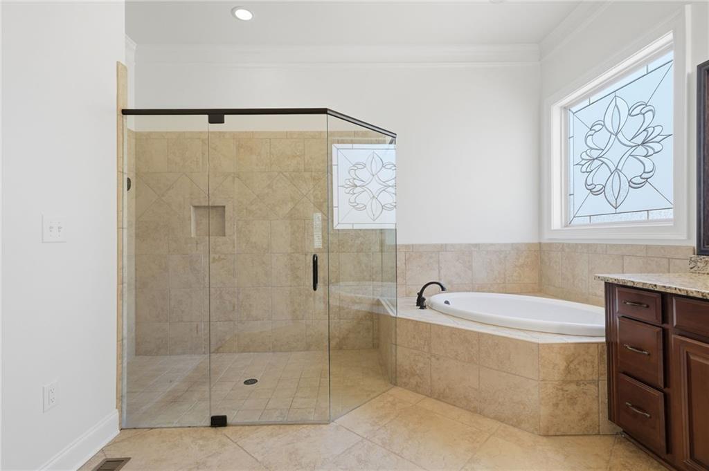 655 Hemlock Trail Canton, GA 30114 - Photo 37 of 58 a bathroom with a bathtub and a shower