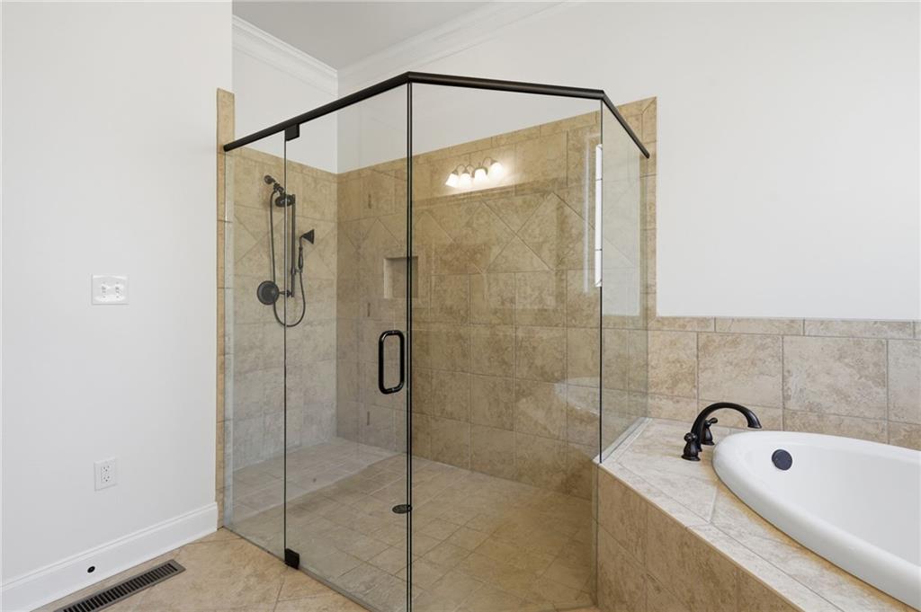 655 Hemlock Trail Canton, GA 30114 - Photo 38 of 58 a bathroom with a shower and a bathtub