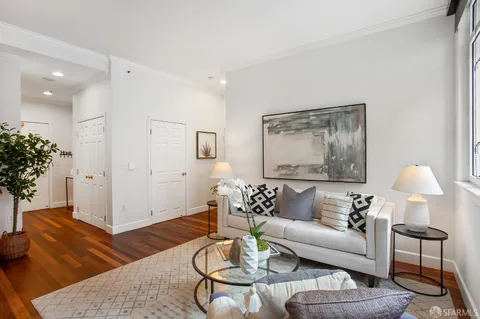 a living room with furniture and flowers