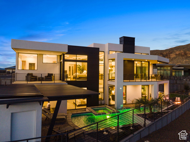 3558 South Cypress Road Hurricane, UT 84737 - Photo 45 of 57 Back house at dusk featuring a balcony, a patio, and a pool with hot tub