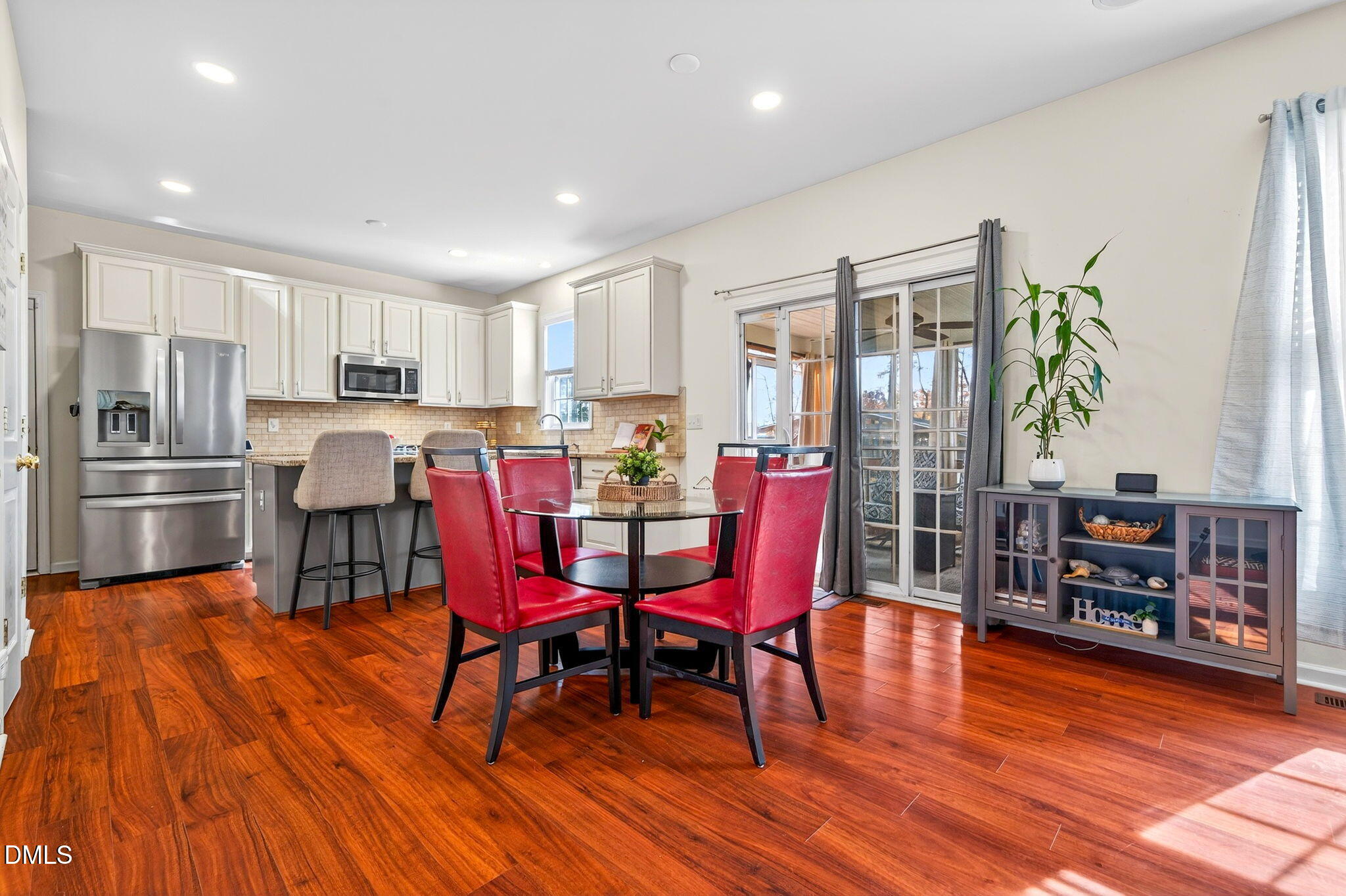 708 Quiet Walk Circle Rolesville, NC 27571 - Photo 12 of 56 a view of a dining room with furniture window and wooden floor