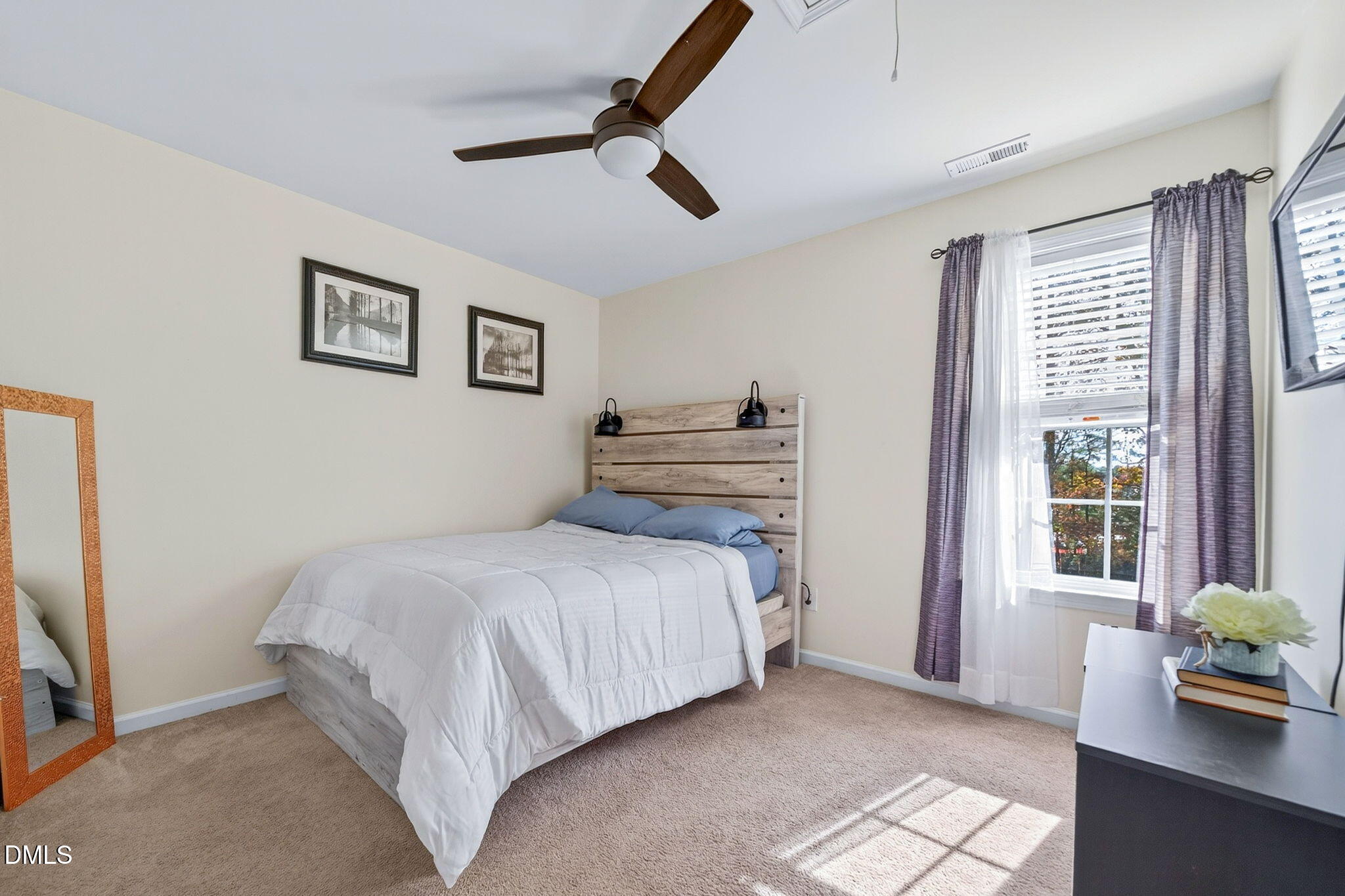 708 Quiet Walk Circle Rolesville, NC 27571 - Photo 29 of 56 a bedroom with a bed and a large window