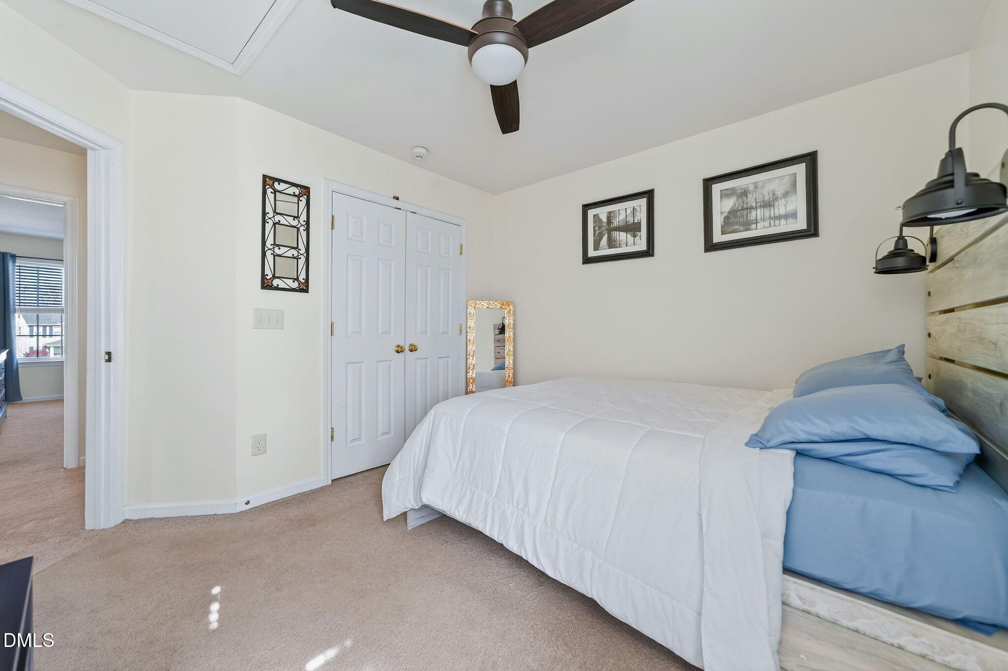 708 Quiet Walk Circle Rolesville, NC 27571 - Photo 30 of 56 a bedroom with a bed and a chandelier