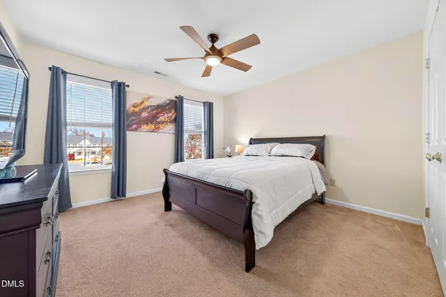 a living room with furniture ceiling fan and a flat screen tv