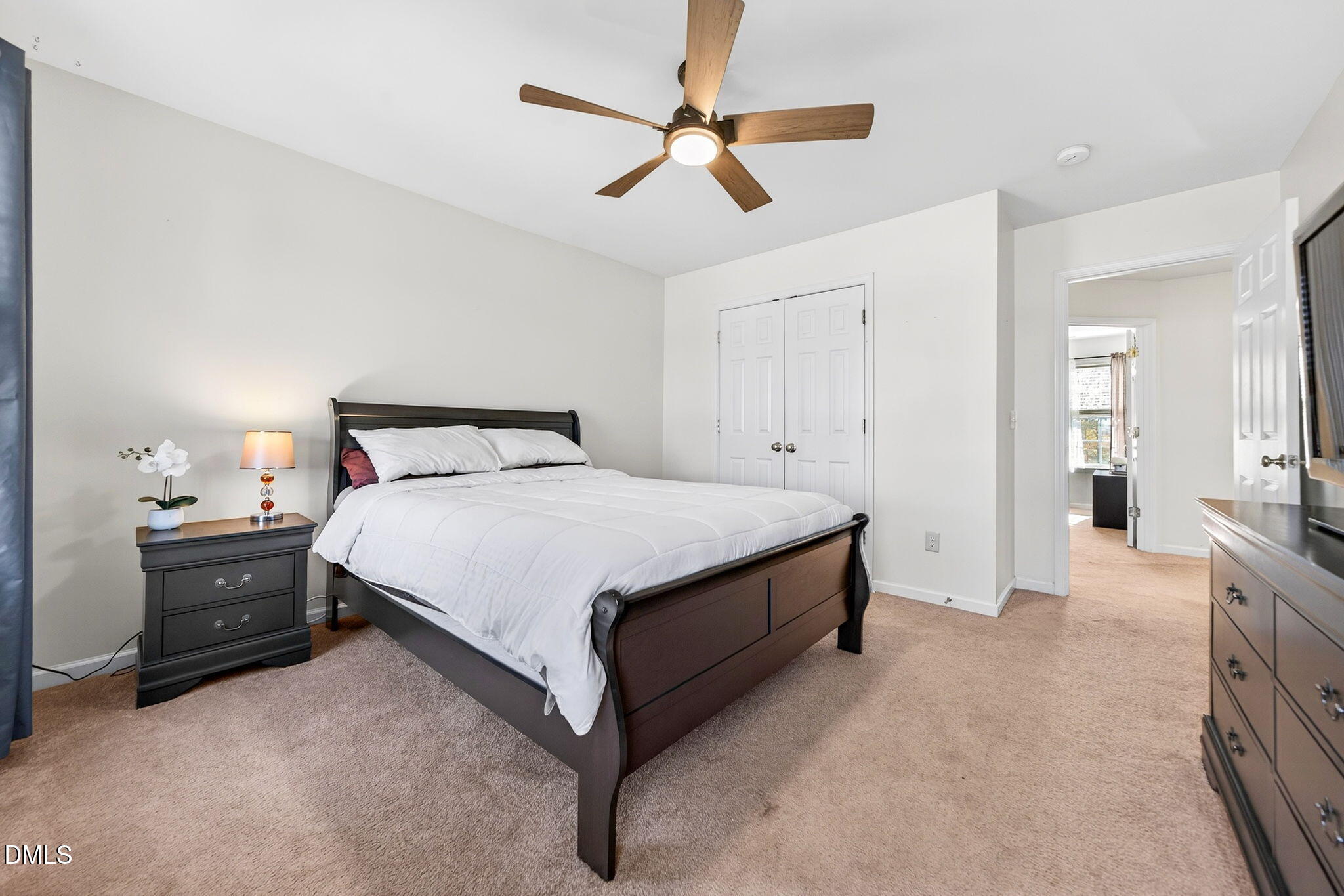 708 Quiet Walk Circle Rolesville, NC 27571 - Photo 32 of 56 a spacious bedroom with a bed and a chandelier