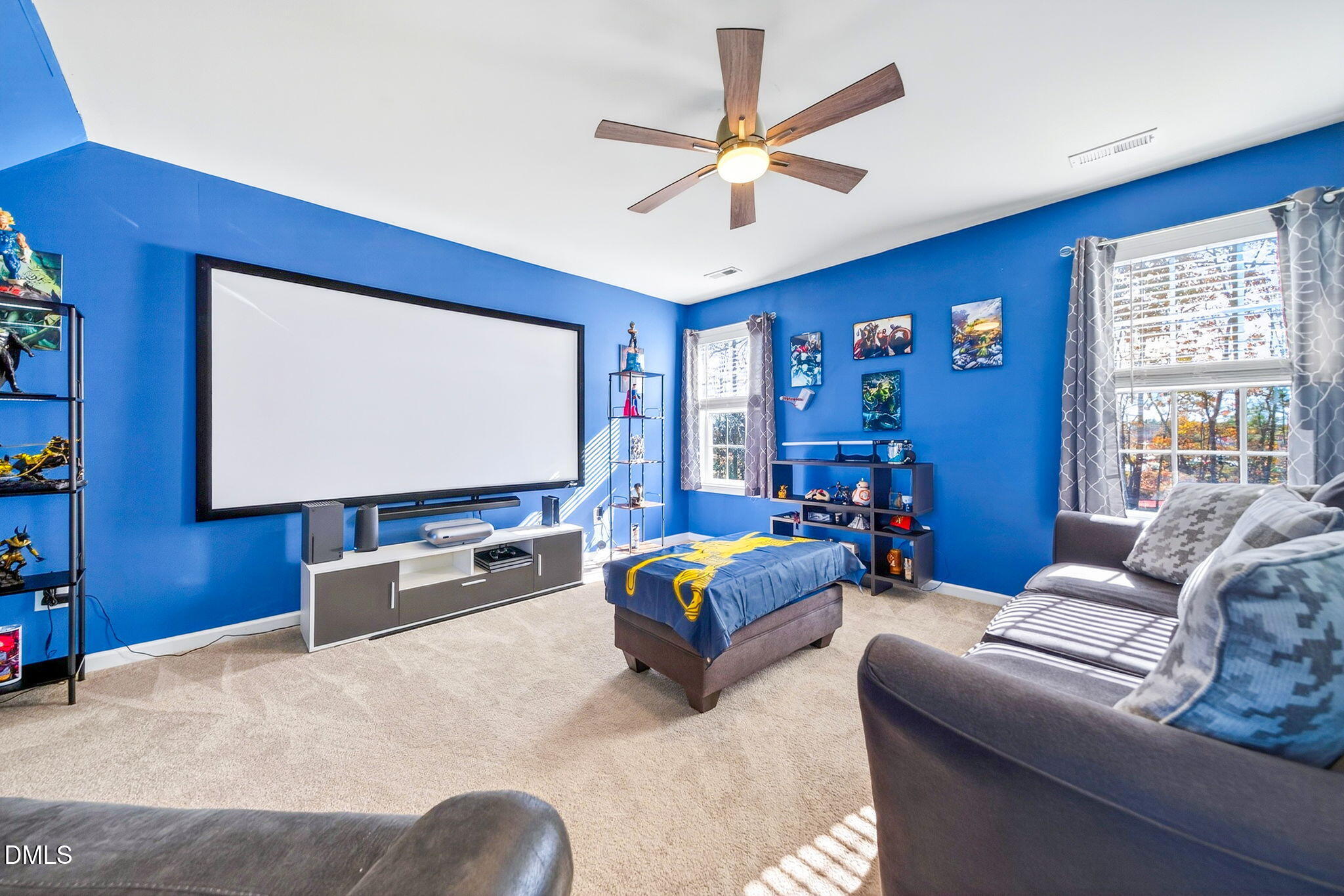 708 Quiet Walk Circle Rolesville, NC 27571 - Photo 34 of 56 a living room with furniture ceiling fan and a flat screen tv