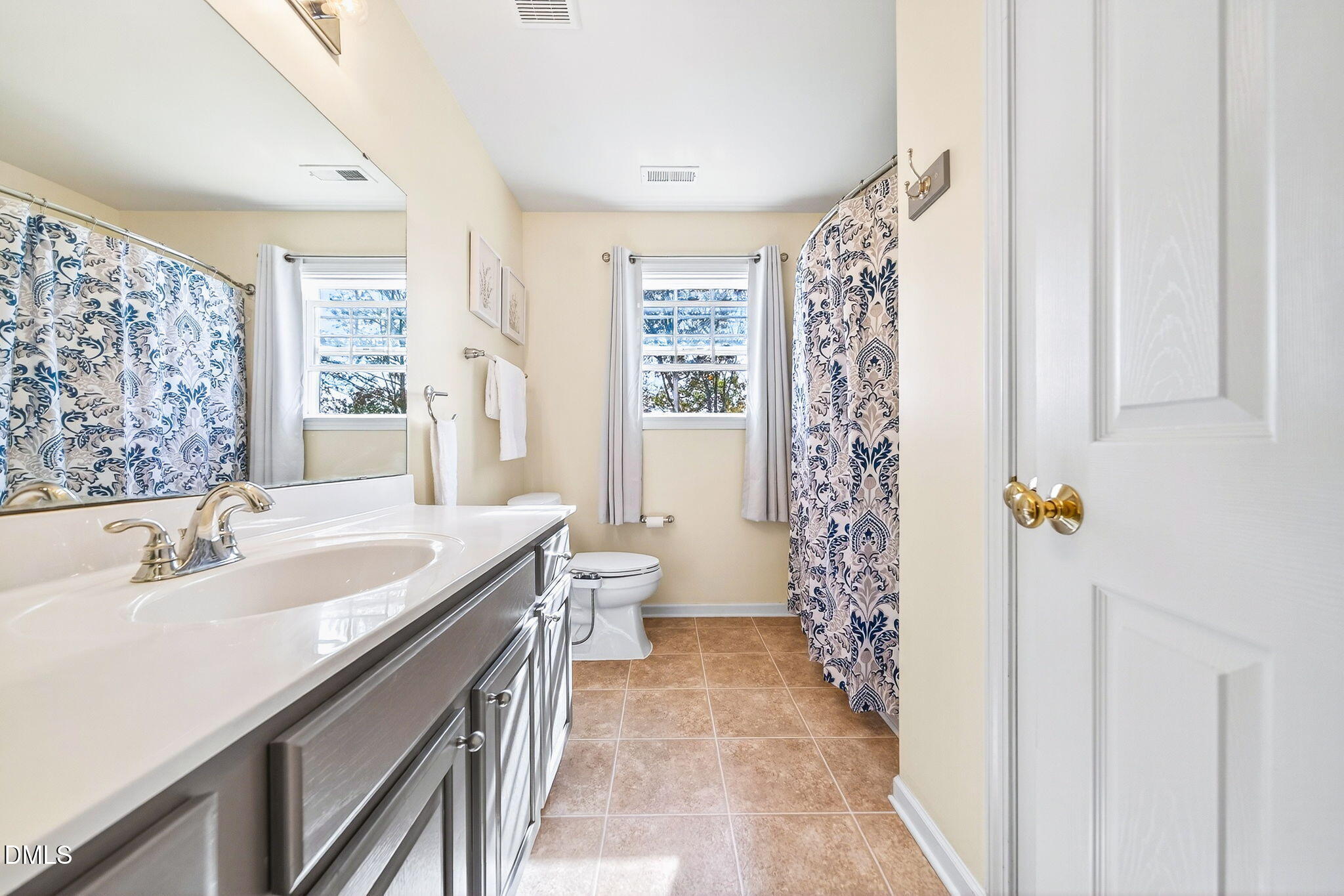 708 Quiet Walk Circle Rolesville, NC 27571 - Photo 39 of 56 a spacious bathroom with a double vanity sink a toilet and a shower